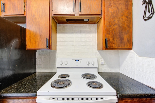 kitchen with electric range and backsplash