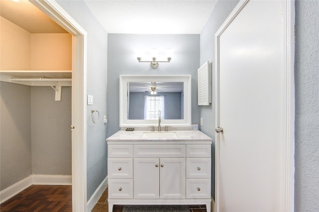 bathroom with vanity and baseboards