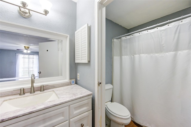 full bathroom with toilet, a ceiling fan, and vanity