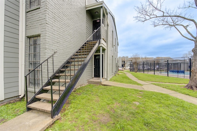 exterior space featuring fence, stairway, and a fenced in pool