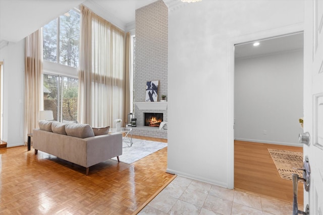 living room featuring baseboards, a high ceiling, parquet flooring, a fireplace, and recessed lighting