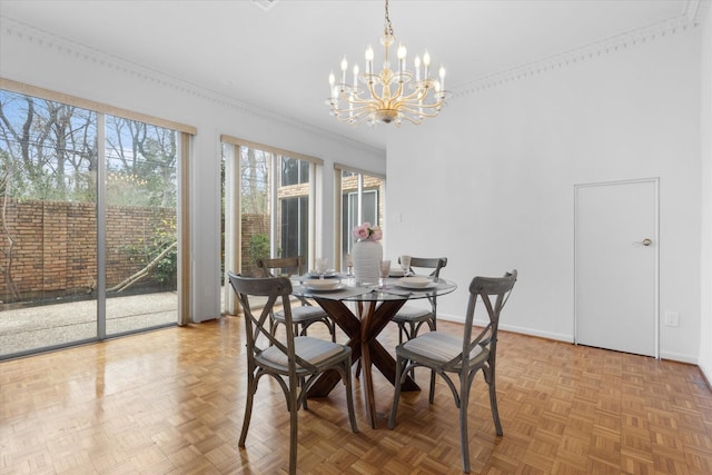 dining area featuring baseboards, a chandelier, and ornamental molding