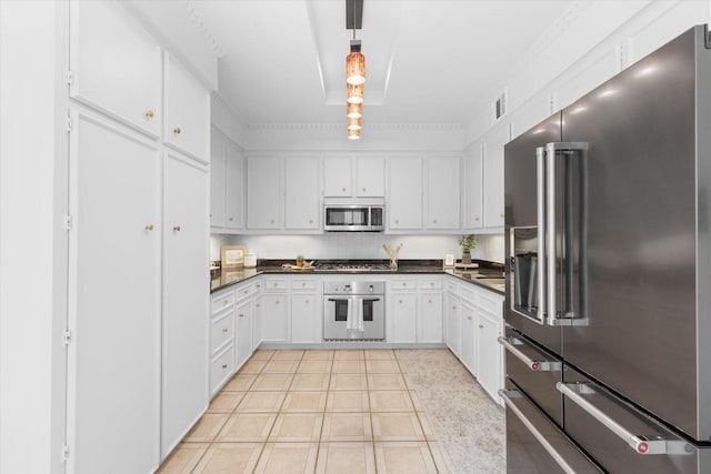 kitchen featuring decorative light fixtures, dark countertops, visible vents, appliances with stainless steel finishes, and white cabinets