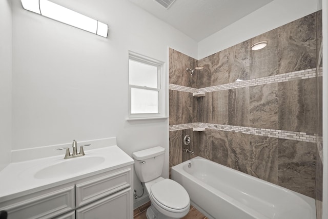 bathroom featuring toilet, tub / shower combination, and vanity