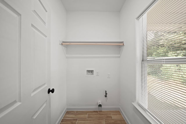 clothes washing area with baseboards, laundry area, hookup for a washing machine, and wood tiled floor