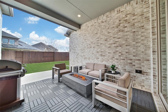 view of patio / terrace with fence private yard, an outdoor living space with a fire pit, and a grill