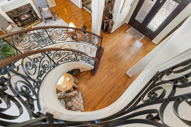 foyer with a healthy amount of sunlight, wood finished floors, and a high end fireplace