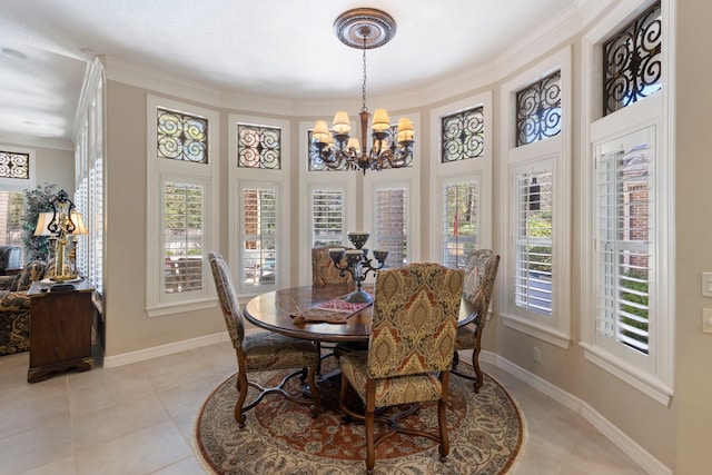 dining room with light tile patterned floors, crown molding, baseboards, and an inviting chandelier