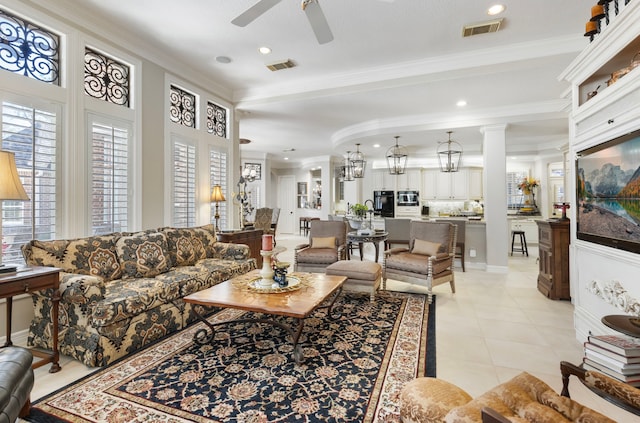 living area with a ceiling fan, visible vents, crown molding, and light tile patterned flooring