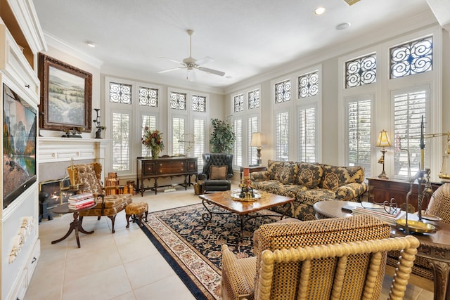 sunroom featuring a ceiling fan and a glass covered fireplace