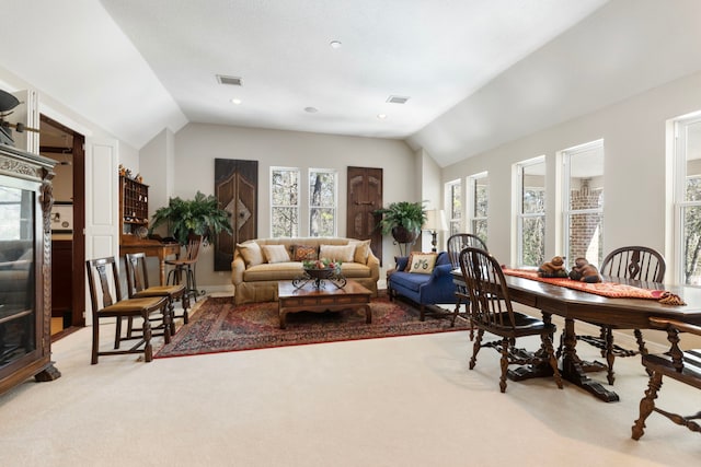 living area featuring vaulted ceiling, recessed lighting, visible vents, and light colored carpet