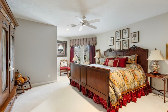 bedroom featuring ceiling fan, baseboards, and light colored carpet