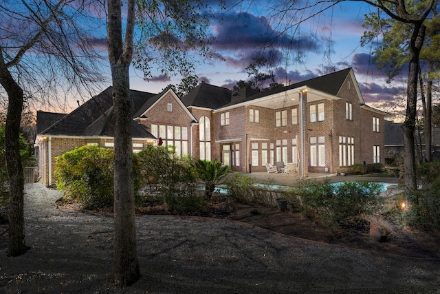 rear view of property with brick siding