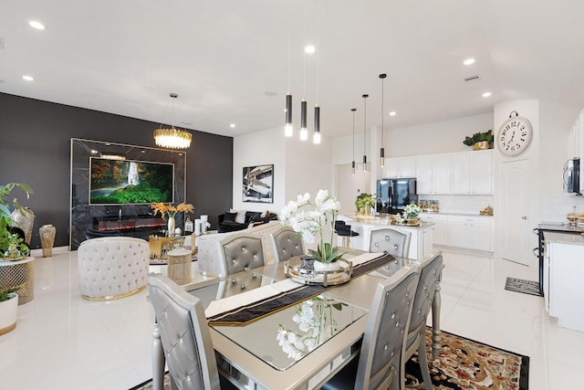 dining room featuring light tile patterned flooring, a chandelier, and recessed lighting