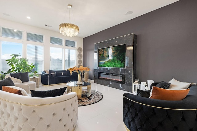 living room with a fireplace, a notable chandelier, recessed lighting, visible vents, and light tile patterned flooring