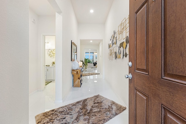 entrance foyer with light tile patterned flooring and baseboards