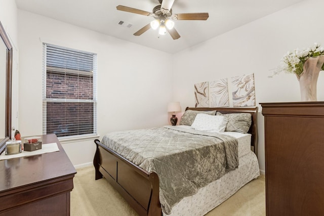 bedroom featuring light carpet, baseboards, visible vents, and ceiling fan