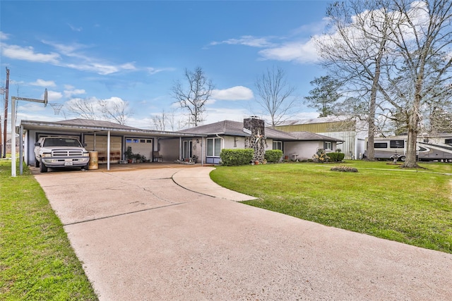 view of front of home featuring concrete driveway, an attached carport, and a front yard