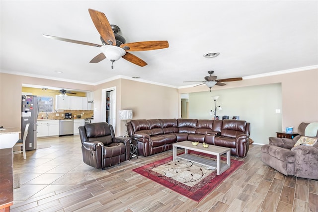 5826 Russell Ln, Baytown, TX 77521 - living room featuring wood tiled floor, visible vents, and crown molding