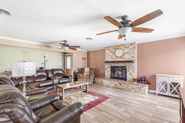 5826 Russell Ln, Baytown, TX 77521 - living room featuring visible vents, crown molding, light wood finished floors, and a fireplace