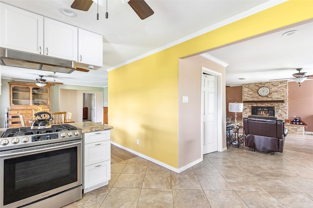 5826 Russell Ln, Baytown, TX 77521 - kitchen with a ceiling fan, white cabinets, and stainless steel range with gas stovetop