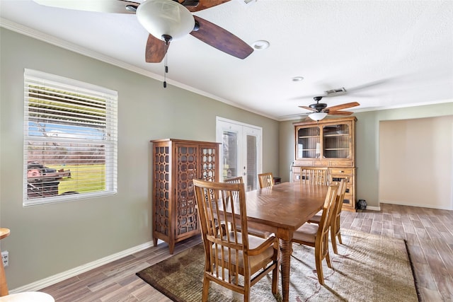 5826 Russell Ln, Baytown, TX 77521 - dining area featuring french doors, visible vents, crown molding, and wood finished floors