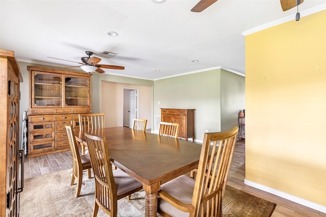 5826 Russell Ln, Baytown, TX 77521 - dining area with a ceiling fan, visible vents, ornamental molding, and light wood finished floors