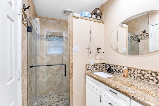 5826 Russell Ln, Baytown, TX 77521 - bathroom featuring tasteful backsplash, visible vents, vanity, and a shower stall
