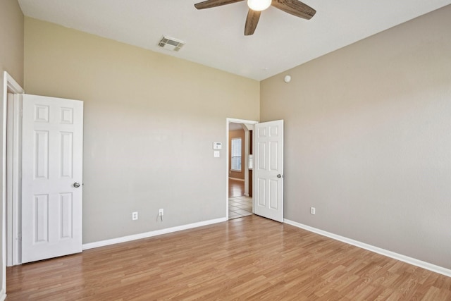 unfurnished bedroom featuring light wood-style floors, visible vents, ceiling fan, and baseboards