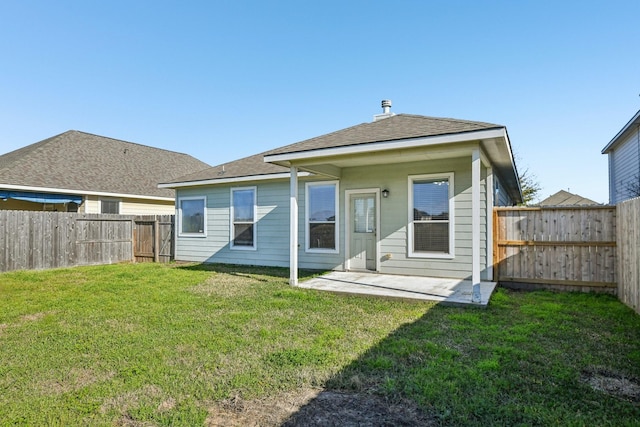 back of property featuring a patio area, a fenced backyard, a yard, and roof with shingles