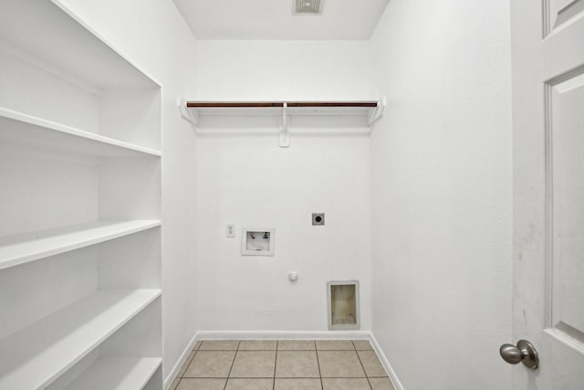 laundry area featuring light tile patterned floors, hookup for a gas dryer, laundry area, washer hookup, and electric dryer hookup