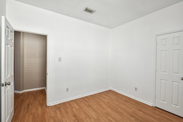 unfurnished bedroom with baseboards, visible vents, and light wood finished floors