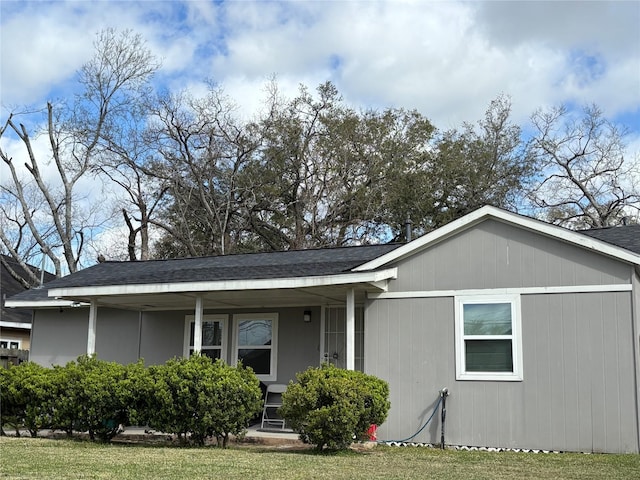 view of front facade with covered porch and a shingled roof