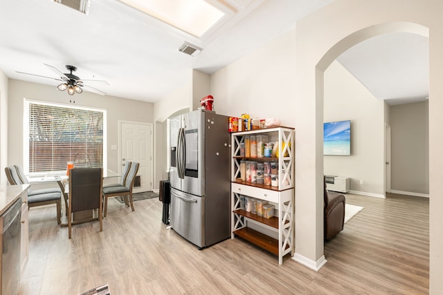 kitchen featuring stainless steel appliances, arched walkways, and visible vents