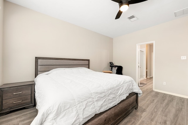 bedroom with light wood-style floors, visible vents, ceiling fan, and baseboards