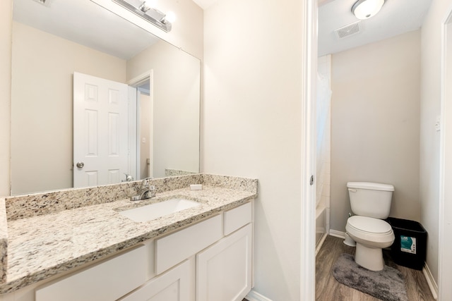 full bathroom featuring toilet, shower / tub combo, wood finished floors, vanity, and visible vents