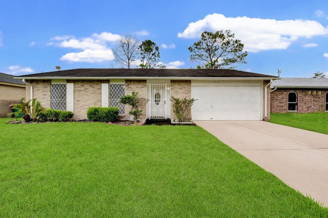 ranch-style house featuring a garage, concrete driveway, brick siding, and a front yard