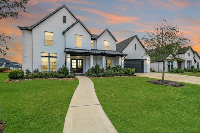 modern farmhouse style home with covered porch, brick siding, a yard, concrete driveway, and a standing seam roof