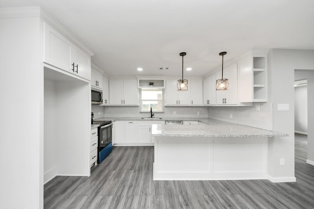 kitchen featuring range with electric cooktop, stainless steel microwave, a peninsula, white cabinetry, and open shelves