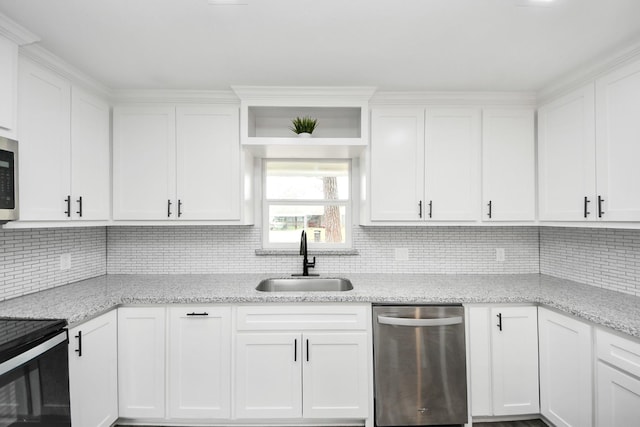 kitchen featuring light stone counters, electric range oven, white cabinets, a sink, and dishwasher