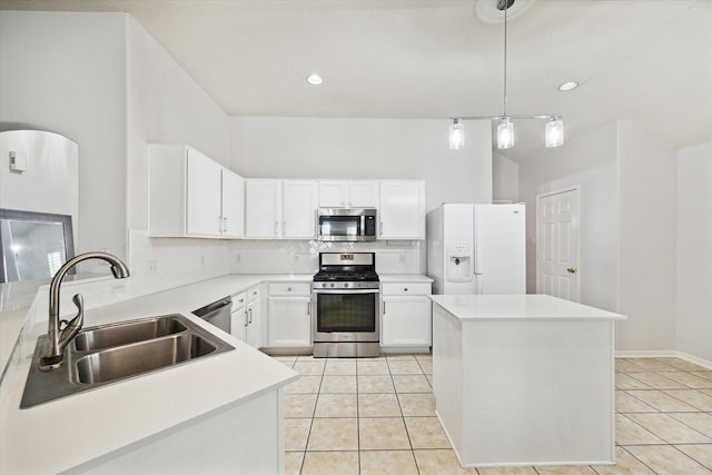 kitchen with light countertops, hanging light fixtures, appliances with stainless steel finishes, white cabinets, and a sink