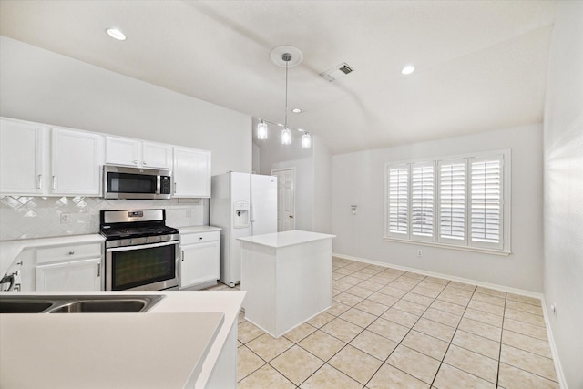 kitchen featuring light countertops, appliances with stainless steel finishes, white cabinets, and a center island