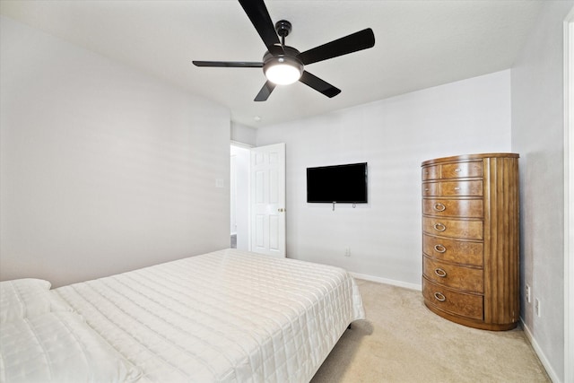 bedroom with light colored carpet, ceiling fan, and baseboards