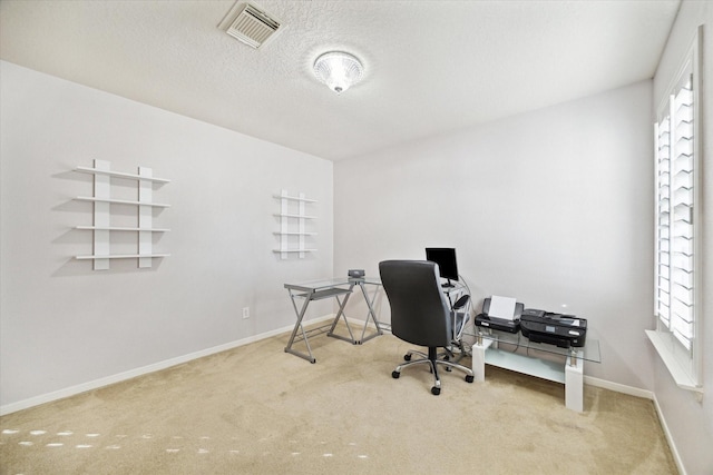 office space featuring carpet floors, visible vents, and plenty of natural light