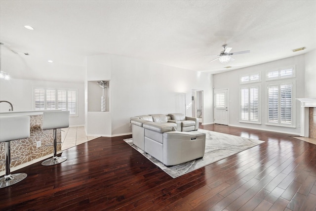 living room with a healthy amount of sunlight, visible vents, and wood finished floors