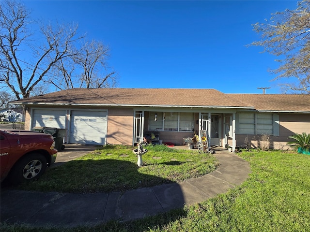 ranch-style house featuring a garage and a front yard