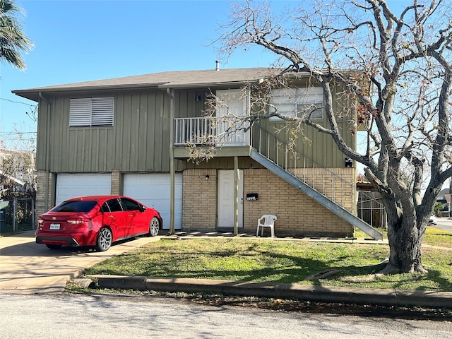 view of front of house with a balcony, an attached garage, a front lawn, and concrete driveway