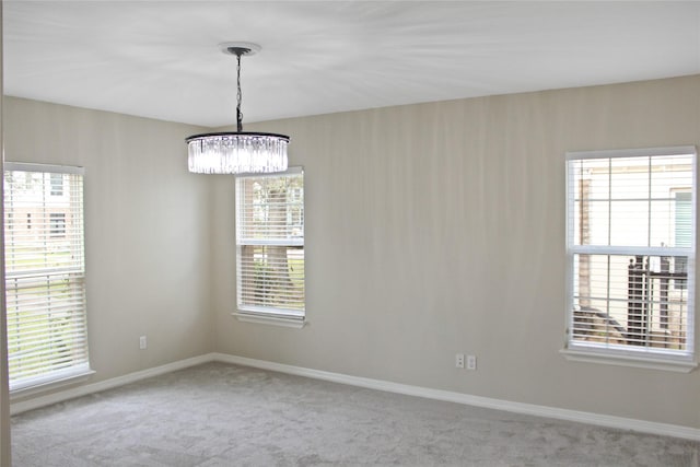 carpeted empty room with baseboards