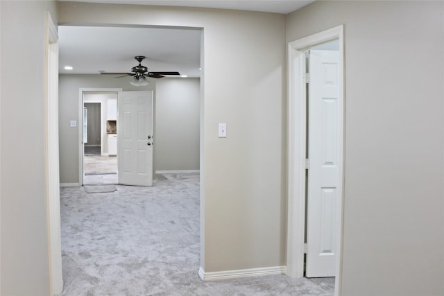 corridor featuring carpet flooring and baseboards