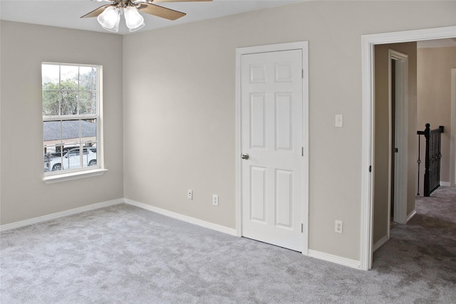 unfurnished bedroom with carpet flooring, ceiling fan, and baseboards